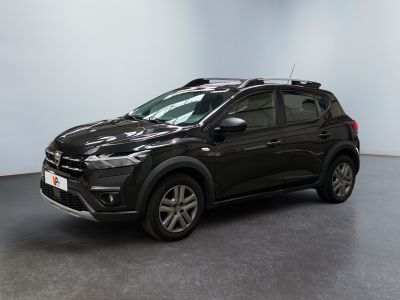 a black car parked in a room with a white wall