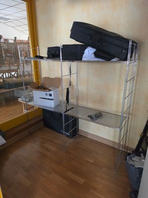 a room with a bed, luggage, and a window