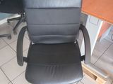a black office chair that is sitting in front of a desk