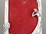 silver plated picture frame with red velvet backing and a lady holding a flower