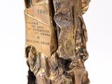 a bronze statue of a man holding a book