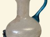 a white and blue vase with a bird on it