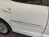 a white car that has been damaged and is parked in a garage