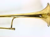 brass trumpet on a white surface with a white background