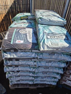 many bags of cement sitting on top of a pallet