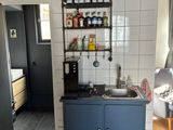 a kitchen with a sink and a blue cabinet in it