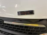 a close up of a white truck with a sticker on the front of it
