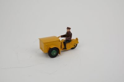 a yellow toy truck with a man sitting on it