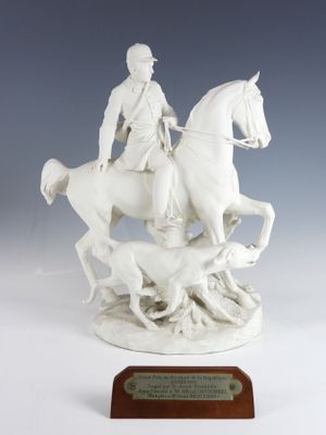statue of a man on a horse with a dog and a dog