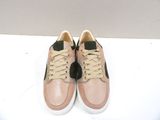 beige and black sneakers with laces on a white surface
