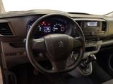 steering wheel and dashboard of a car with a clock on the dashboard
