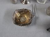 a silver plate with a flower on it and other silver objects