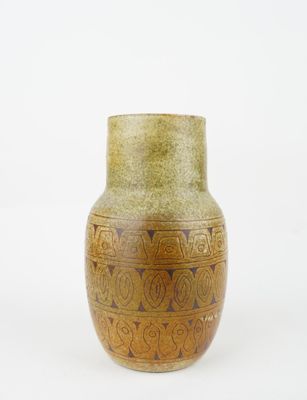yellow and brown vase sitting on a white surface with a white background