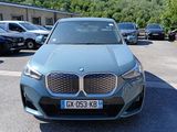 a blue bmw suv parked in a parking lot