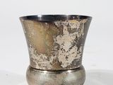 an image of a silver cup sitting on top of a white surface