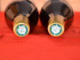 two bottles of wine that are sitting on a table