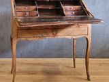 a wooden desk with a drawer on it on a hard wood floor