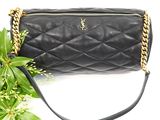 black leather handbag with gold chain strap and chain strap
