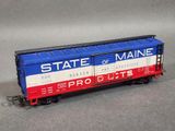 an image of a red, white and blue train car with a state of maine on the side