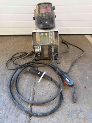 a welding machine and a hose on the ground