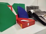 many different colored folders on a white table