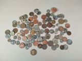 a pile of old coins on a white surface