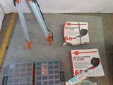 a tripod that is sitting on the ground next to other items