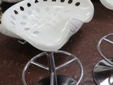 quatre tabourets blancs posés sur une table dans une pièce