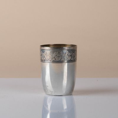 a silver cup that is sitting on a table