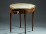a small table with a marble top and wooden legs