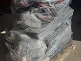 a pile of luggage sitting on top of a pallet in a warehouse