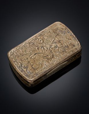 a silver box with a design of flowers and leaves on it