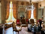 a living room with a lot of furniture and a chandelier