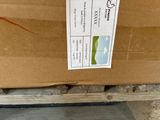 a cardboard box with a label on it sitting on a pallet