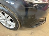a close up of a car ' s front bumper with a denting on it