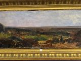 une image d'un tableau représentant un paysage dans un cadre doré
