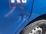 a blue truck with a red and white sticker on the side of it