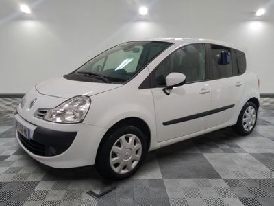 a picture of a small white car parked in a garage