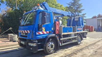 a blue truck that is parked on the side of the road