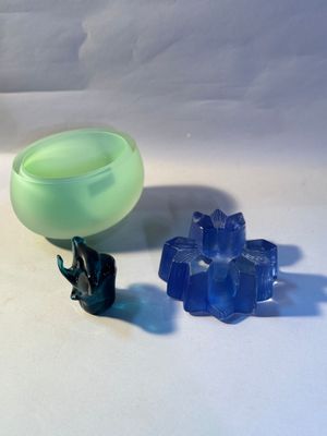 a green cup and a blue glass on a white table