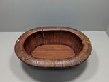 a wooden bowl sitting on top of a white table