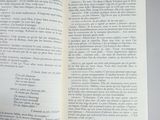 someone is holding a book open to a page with a picture of a cat