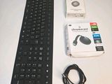 a keyboard and mouse on a table with a box of headphones