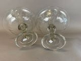 two empty wine glasses sitting on top of a table