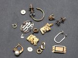 a bunch of different types of jewelry on a black surface