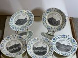 five plates with blue flowers on them sitting on a table