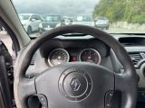 dashboard view of a car with a steering wheel and dashboard gauges