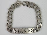 a close up of a silver bracelet with the word be brave on it