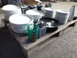 many plates and cups sitting on a wooden pallet