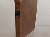 an old book sitting on top of a glass table